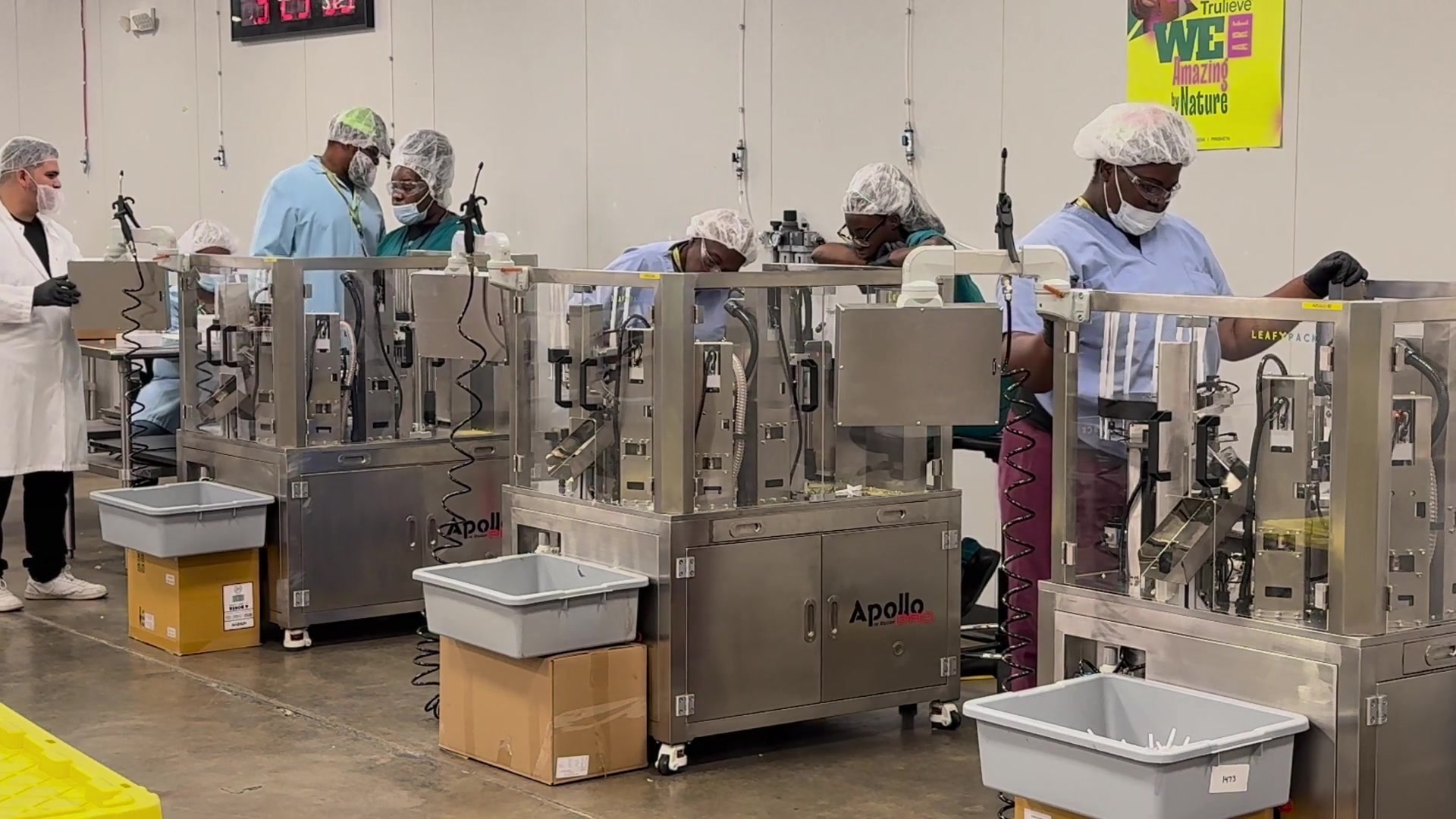 Operators working with earlier Apollo machines on a production floor