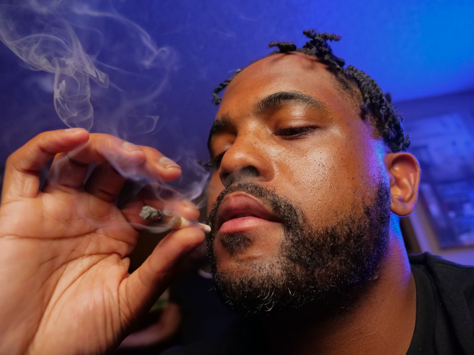 Adult cannabis consumer smoking a pre-roll